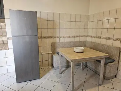 a kitchen with a table and a bowl on it at Maarif Central Stay in Maarif