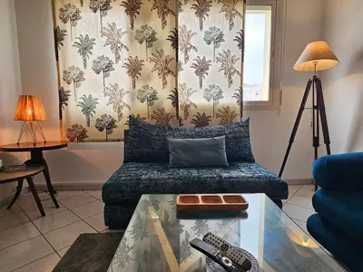 a living room with a couch and a table at Maarif Central Stay in Maarif