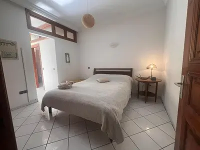 a bedroom with a bed and a table and a window at Maarif Central Stay 2 in Maarif