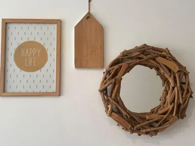 a wreath and a mirror on a wall with a sign at Maarif Central Stay 2 in Maarif