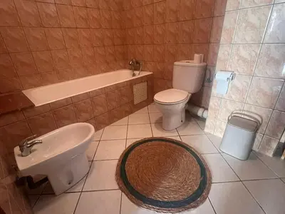 a bathroom with a sink and a toilet and a bath tub at Maarif Central Stay 2 in Maarif