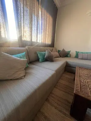 a large couch in a living room with a window at Maarif Central Stay 2 in Maarif