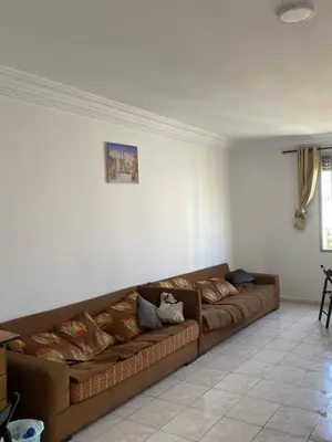 a brown couch sitting in a living room at Happy hostel in Casablanca