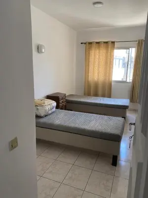 two beds in a room with a window at Happy hostel in Casablanca