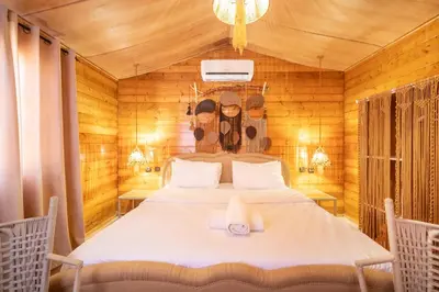 a bedroom with a bed in a wooden room at Lakala Complexe Touristique in O Ben Slimane