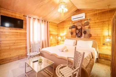 a bedroom with a bed and a table and chairs at Lakala Complexe Touristique in O Ben Slimane