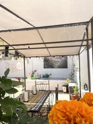 a patio with a table and chairs under a tent at Dar EL BAHIA - Spacious flat with large Terrace in Casablanca