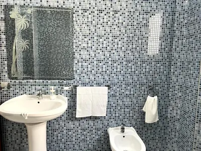 a bathroom with a sink and a mirror at Dar EL BAHIA - Spacious flat with large Terrace in Casablanca