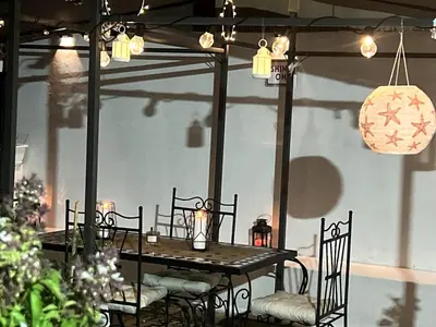 a dining room table with chairs and lights at Dar EL BAHIA - Spacious flat with large Terrace in Casablanca
