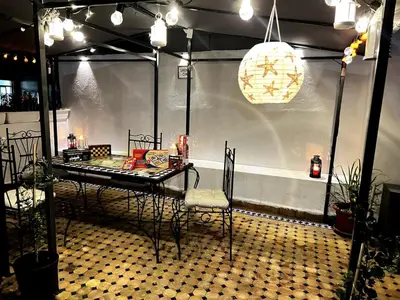 a room with a table and chairs on a floor at Dar EL BAHIA - Spacious flat with large Terrace in Casablanca