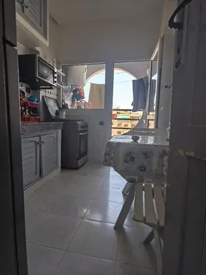a small kitchen with a table and a window at Mydar ocean in Rabat