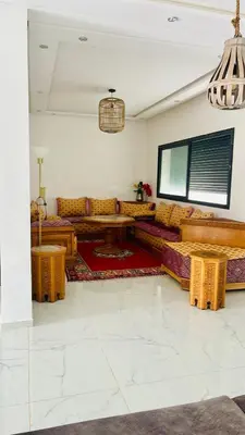 a living room with couches and a table at Spacieuse villa oued cherrat bouznika in Bouznika