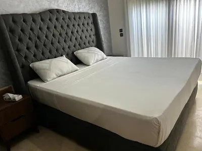 a bedroom with a large bed with a padded headboard at Modern Studio by the Beach of Casablanca Night Stay in Casablanca