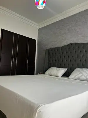 a bedroom with a large white bed with a headboard at Modern Studio by the Beach of Casablanca Night Stay in Casablanca