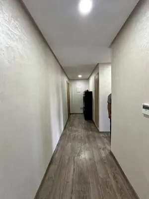 an empty hallway with white walls and wood floors at Les jardins de cherrat in Bouznika