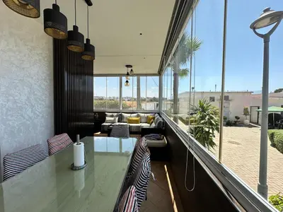 a balcony with a bar with a view of a patio at Les jardins de cherrat in Bouznika