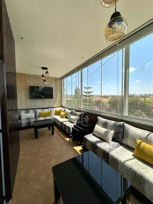 a large living room with couches and a large window at Les jardins de cherrat in Bouznika