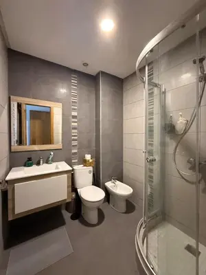a bathroom with a toilet and a sink and a shower at Appartement Moderne 2 chambres à Blanca Beach Sidi Rahal in Sidi Rahal