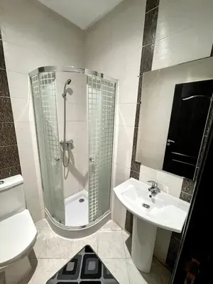 a bathroom with a shower and a sink at Appartement à Sidi Rahal Piscine et Accès direct plage in Sidi Rahal