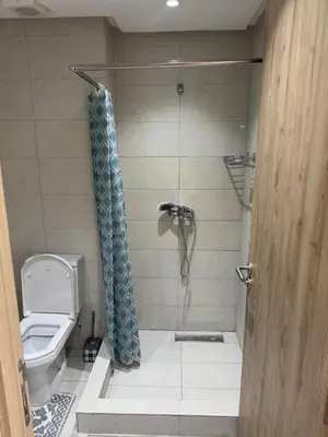 a bathroom with a shower and a toilet at Blue dhalia beach a sidi rahal in Dar Oulad Hajj Kassem