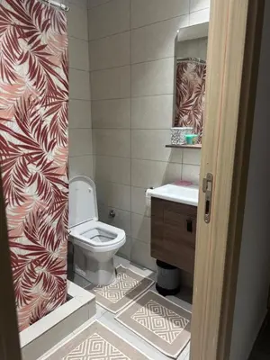 a bathroom with a toilet and a sink at Blue dhalia beach a sidi rahal in Dar Oulad Hajj Kassem
