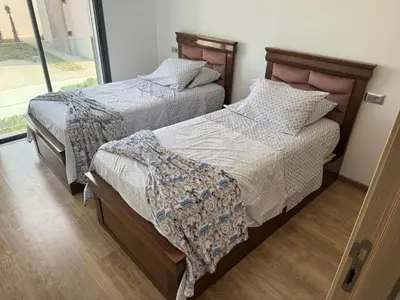 two beds sitting next to each other in a bedroom at Blue dhalia beach a sidi rahal in Dar Oulad Hajj Kassem