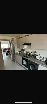 a kitchen with a stove and a counter top at Blue dhalia beach a sidi rahal in Dar Oulad Hajj Kassem