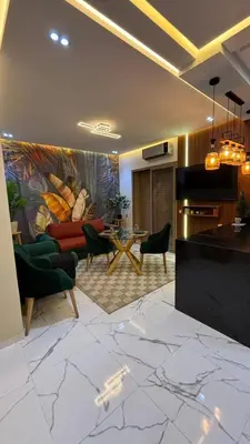 a living room with a couch and a table at Studio lux in Bouznika