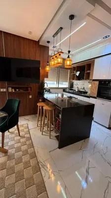 a kitchen with a table and chairs in a room at Studio lux in Bouznika