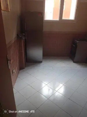 an empty kitchen with a refrigerator in a room at Appartement Alhadika in Casablanca