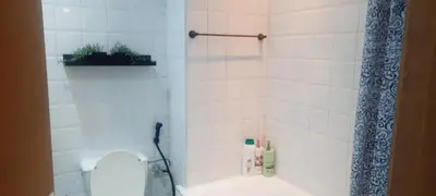 a bathroom with a toilet with a shower curtain at Appartement Alhadika in Casablanca