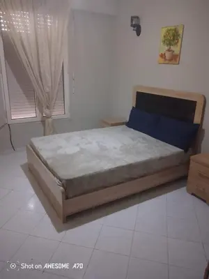 a bed sitting in a room with a window at Appartement Alhadika in Casablanca