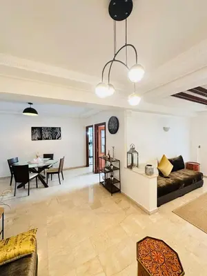 a living room with a couch and a table at Loft12 in Rabat