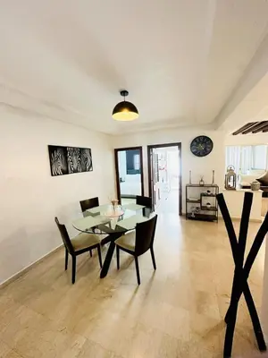 a dining room with a glass table and chairs at Loft12 in Rabat
