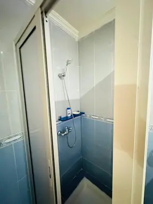 a shower in a bathroom with a blue shower at Loft12 in Rabat