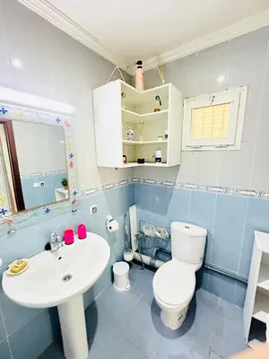 a bathroom with a white toilet and a sink at Loft12 in Rabat