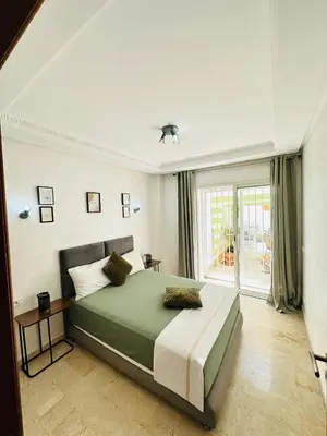 a bedroom with a large bed and a window at Loft12 in Rabat