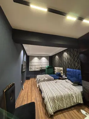 a bedroom with two beds and a tv in it at Escape for the whole family in Casablanca
