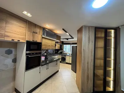 a large kitchen with wooden cabinets and appliances at Escape for the whole family in Casablanca