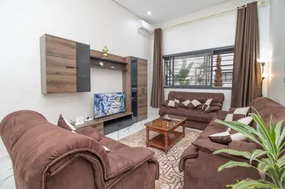 a living room with two couches and a tv at Les rochers in Casablanca