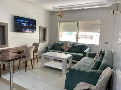 a living room with a couch and a table at Cozy Relax in Mohammedia