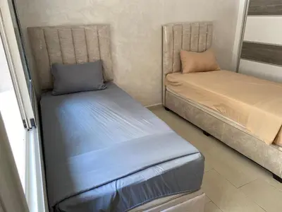 a small room with two beds in a room at Cozy Relax in Mohammedia