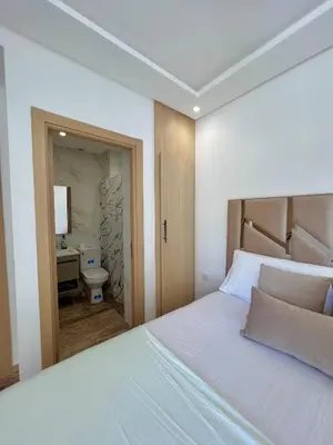 a bedroom with a bed and a bathroom at Heaven Beach Sidi Rahal in Sidi Rahal