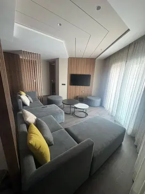 a living room with a couch and a tv at Charming studio ready to live in in Casablanca