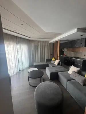 a living room with couches and chairs and a kitchen at Charming studio ready to live in in Casablanca