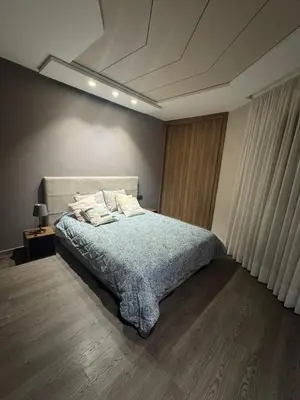 a bedroom with a bed with a blue comforter at Charming studio ready to live in in Casablanca