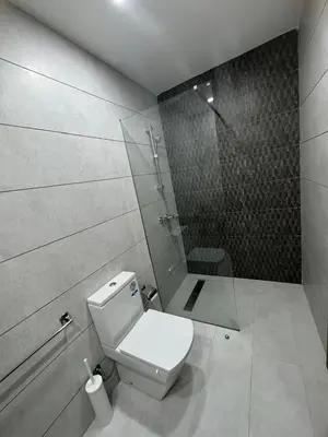 a bathroom with a toilet and a glass shower at Charming studio ready to live in in Casablanca