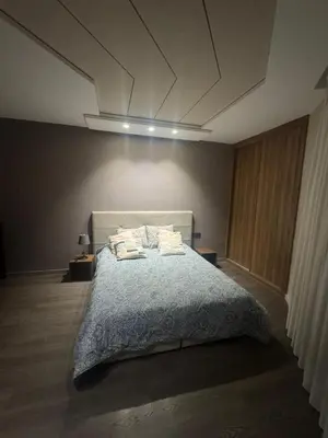 a bedroom with a bed with pillows on it at Charming studio ready to live in in Casablanca