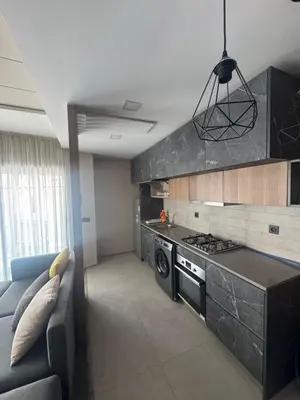 a kitchen with a couch and a stove top oven at Charming studio ready to live in in Casablanca