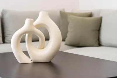 two white vases sitting on a table next to a couch at BRYJ 34 Luxury studio les princesses maarif in Casablanca